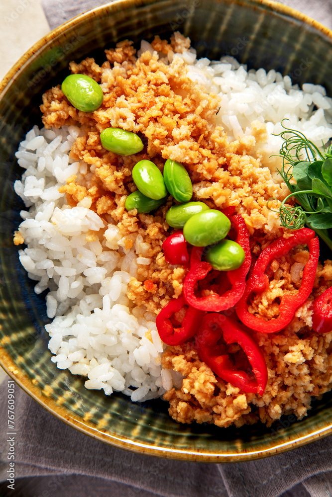 Vegan food. Soy meat, white rice, beans, red pepper on light wooden background Vegan food. Soy meat, white rice, beans, red pepper on light wooden background