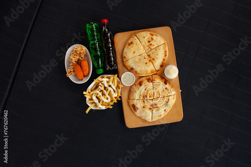 Mediterranean stuffed naan calzone quesadilla with mayo fries peri bites and chicken strips.