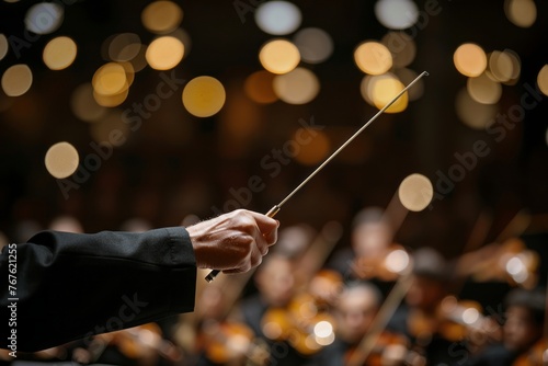 Conductor, orchestra conductor waves his baton. photo