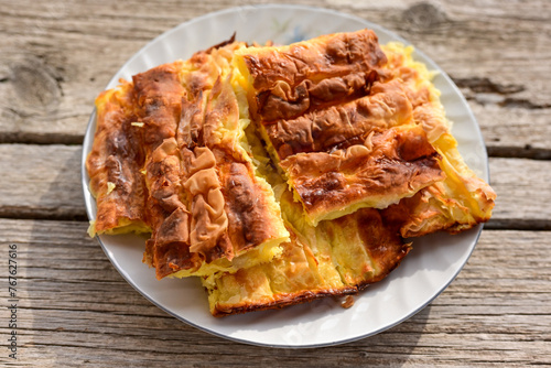 Bakery .Home made  cheese pie  with phyllo pastry, feta cheese  and organic eggs. Bulgarian banitsa © Striker777