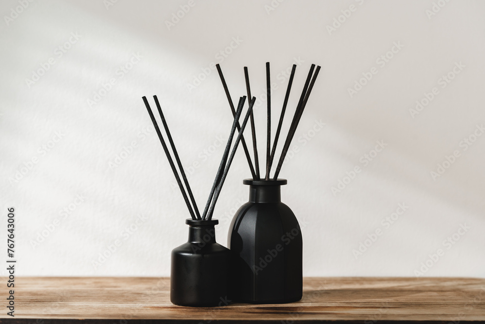 Minimalist Aromatic Reed Diffusers on a Wooden Surface Against a Soft Background - obrazy, fototapety, plakaty 