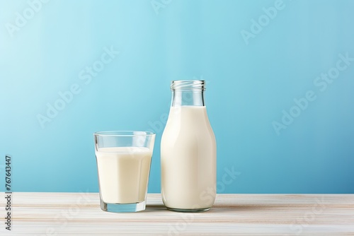 Bottle of milk and glass of milk on wooden table on light blue background. Generative AI
