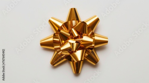 Gold gift bow on white background. Golden gift wrapping ribbon