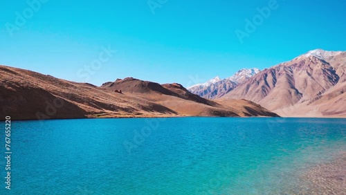 Beautiful landscape view of Chandra Taal Lake with Himalaya mountains in background at Spiti Valley, India. Summer nature landscape. Turquoise water mountain lake.  photo