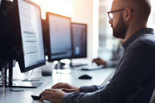 Man at computer, software developer working on coding script or cyber security in bright modern office 