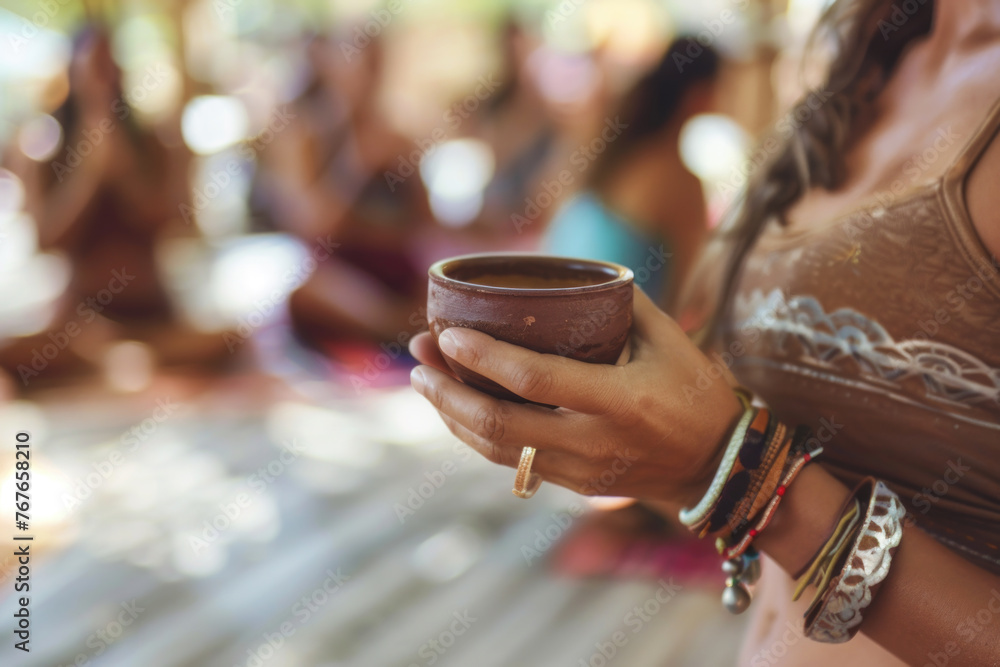 Cacao ceremony, hands of female yoga teacher on Ibiza island, holding a cup of pure organic ceremonial cacao drink. Cacao ceremony, hands of female yoga teacher on Ibiza island, holding a cup of pure organic ceremonial cacao drink.