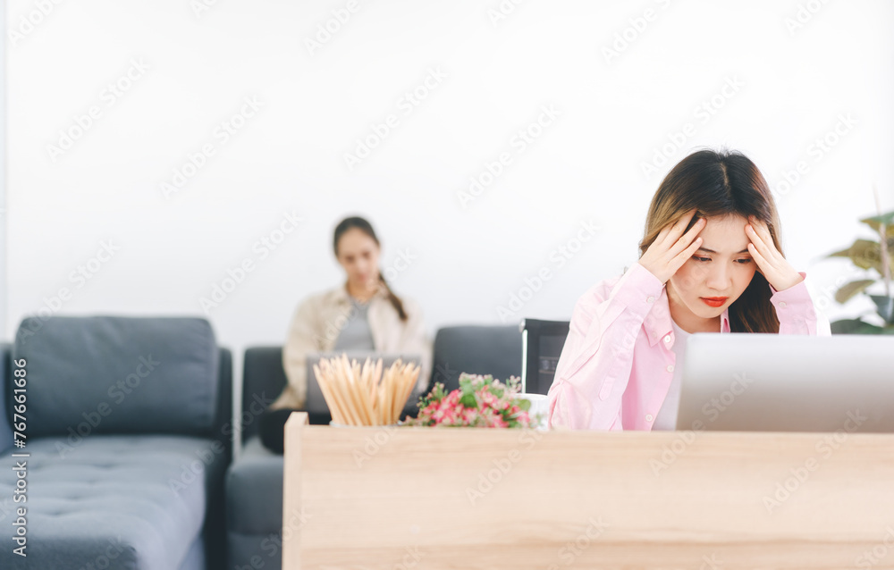 Woman fatique and stress using laptop computer at home office Woman fatique and stress using laptop computer at home office