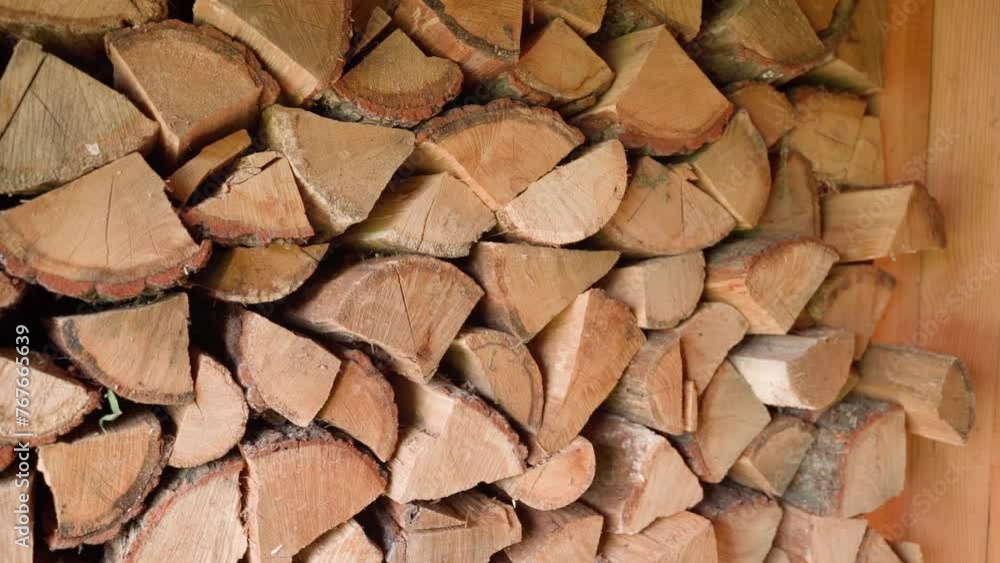 Oak firewood prepared for winter, stacked in a dry place Oak firewood prepared for winter, stacked in a dry place