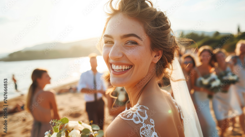 Fototapeta premium Portrait of a happy smiling caucasian woman bride in white dress on her wedding day on the beach with family , friends and sea view in background