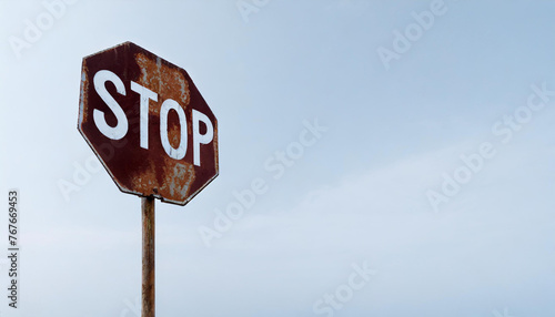 Rusted red traffic STOP sign photo