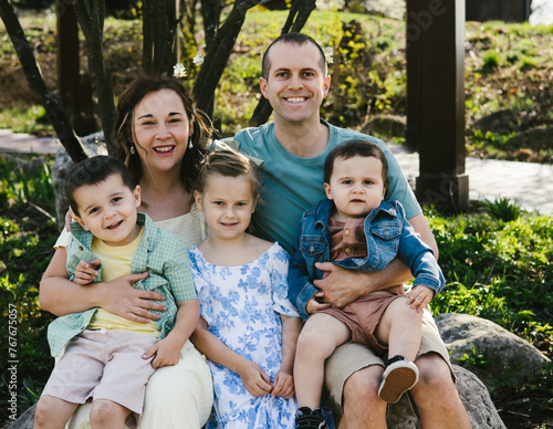 Family in spring colors smiling and laughing together photo