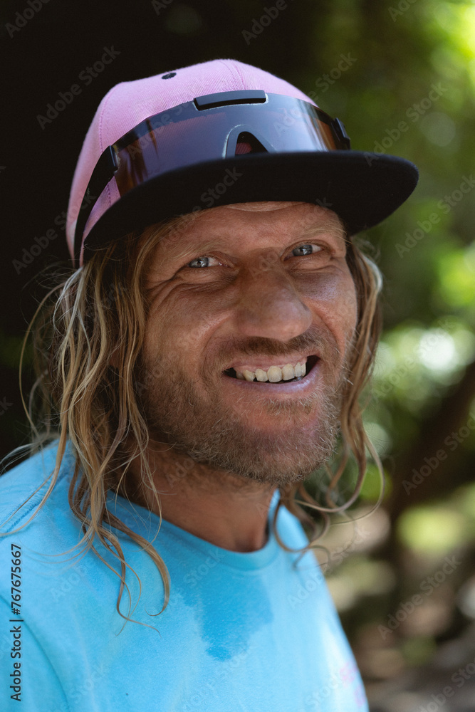 Portrait man surfer with long faded hair wearing a cap and sunglasses. Portrait man surfer with long faded hair wearing a cap and sunglasses.