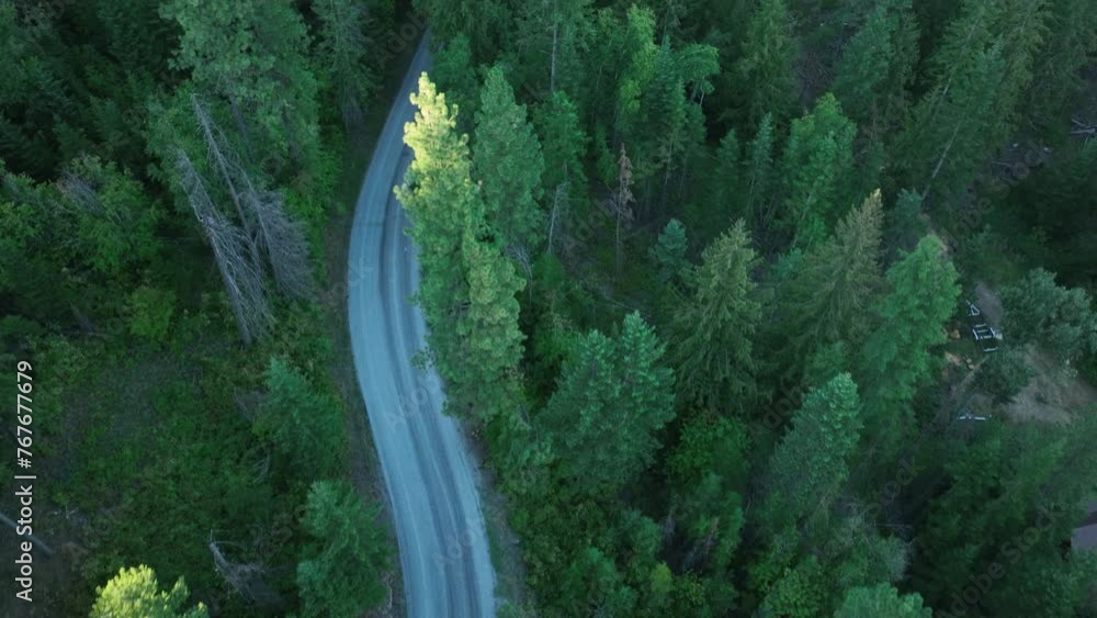 Overhead drone shot of a backcountry road winding through the forest. Overhead drone shot of a backcountry road winding through the forest.