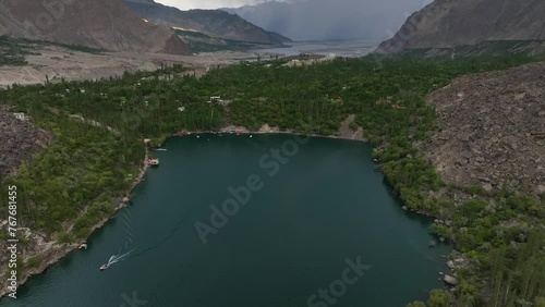 Bird's eye view drone shot of upper kachura lake in Skardu with high mountains in the background photo