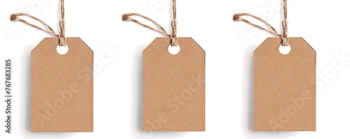 Three brown tags hanging from a string. The tags are empty and have no writing on them