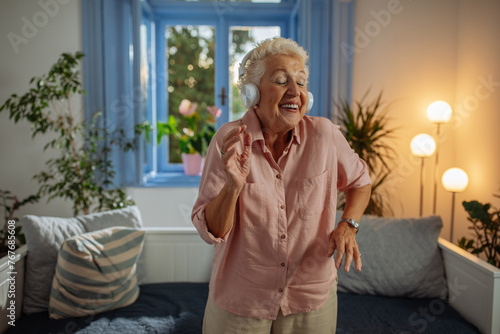 Elderly woman enjoying her music at home