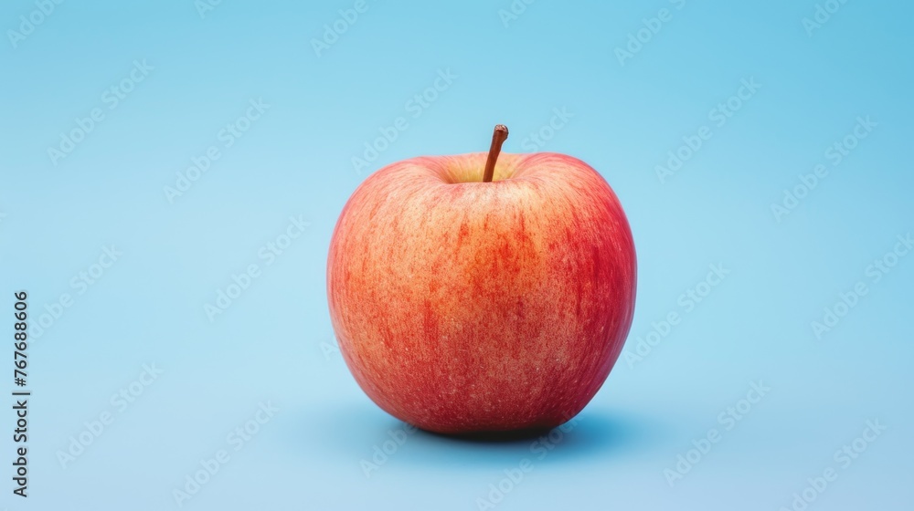 one red apple isolated on a blue background one red apple isolated on a blue background