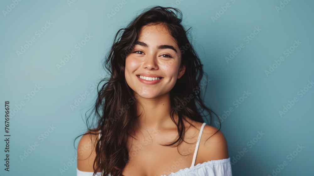 A happy, attractive woman smiles in a studio portrait. A happy, attractive woman smiles in a studio portrait.
