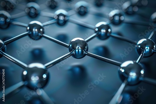 A close up of many small spheres arranged in a grid. The spheres are metallic and appear to be connected to one another. Concept of order and structure photo