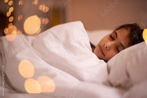 Sleeping, peace and girl child relax in a bed with comfort, dreaming or resting at home. Sleep, dream or calm female kid person in a bedroom for vacation, holiday or nighttime quiet snooze in a house