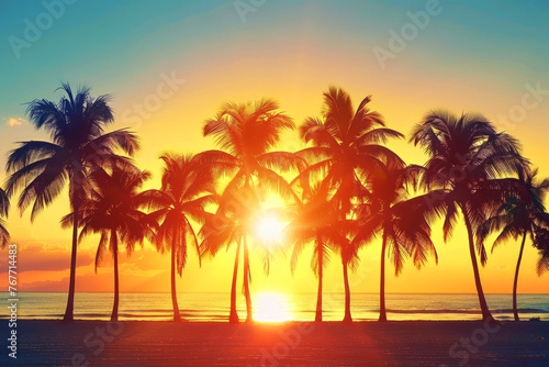 Sunset silhouette of palm trees against a vibrant twilight sky on the beach © thanakrit