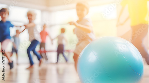 Happy pupils playing with gym ball in gym class 