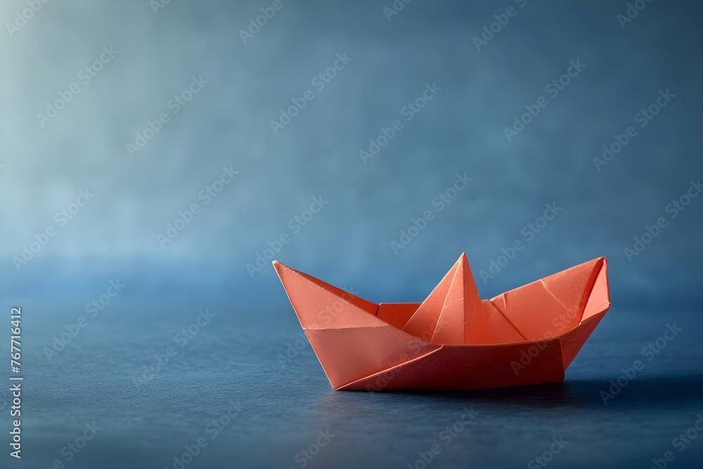 Obraz premium A paper boat sailing on a blue surface symbolizing leadership and innovation in business and social media. Concept Leadership, Innovation, Business, Social Media, Symbolism
