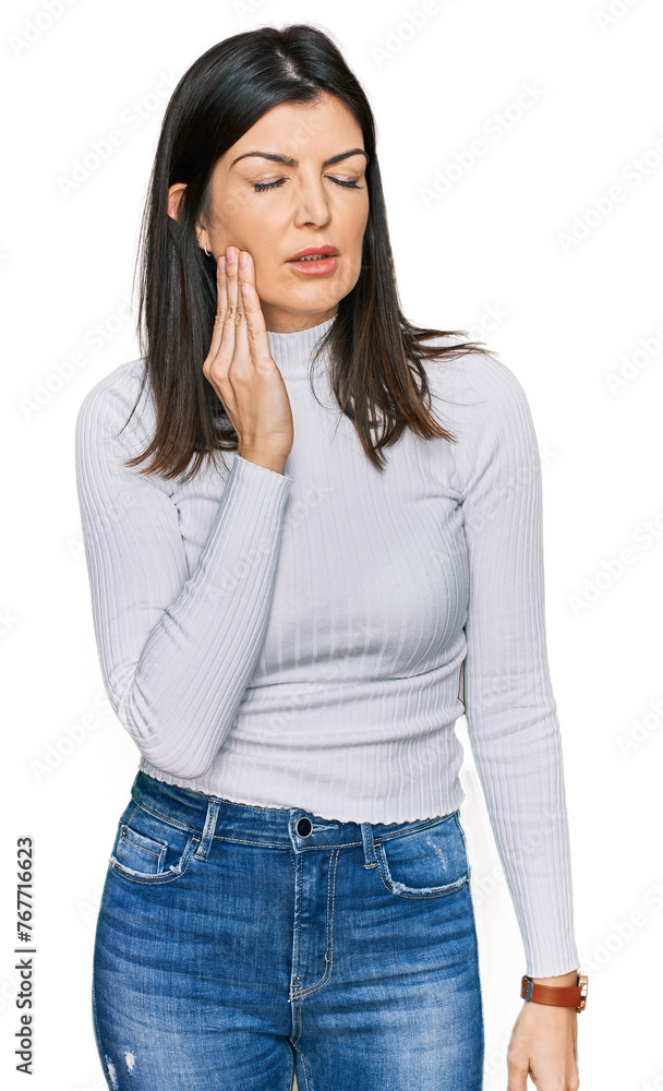 Beautiful brunette woman wearing casual clothes touching mouth with hand with painful expression because of toothache or dental illness on teeth. dentist Beautiful brunette woman wearing casual clothes touching mouth with hand with painful expression because of toothache or dental illness on teeth. dentist