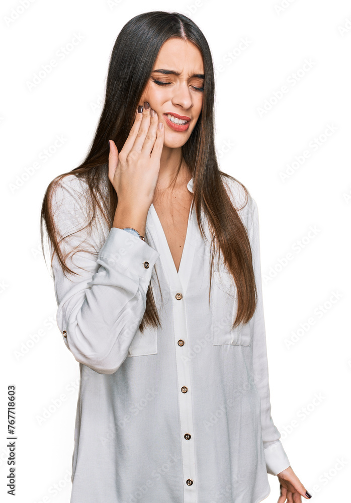 Young beautiful woman wearing casual white shirt touching mouth with hand with painful expression because of toothache or dental illness on teeth. dentist Young beautiful woman wearing casual white shirt touching mouth with hand with painful expression because of toothache or dental illness on teeth. dentist