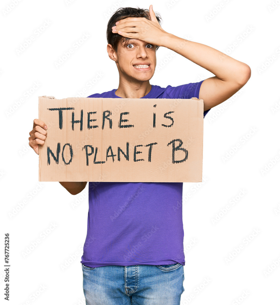 Young hispanic man holding there is no planet b banner stressed and frustrated with hand on head, surprised and angry face Young hispanic man holding there is no planet b banner stressed and frustrated with hand on head, surprised and angry face