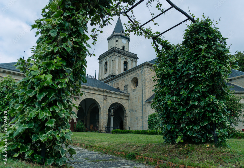 Arceniega church behind the entrance with plants