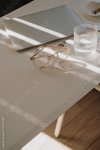 Home office workspace in soft aesthetic sun light glare and shadows