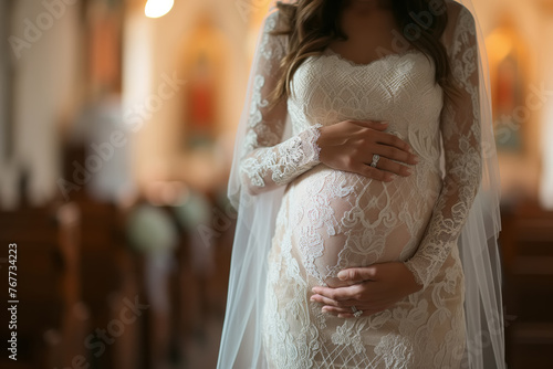 A pregnant African American woman in a white wedding dress stands in a church. She is clearly expecting, showcasing the beauty of motherhood on her special day