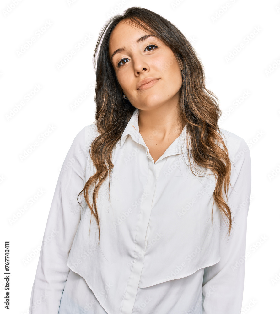Young brunette woman wearing casual clothes relaxed with serious expression on face. simple and natural looking at the camera. Young brunette woman wearing casual clothes relaxed with serious expression on face. simple and natural looking at the camera.