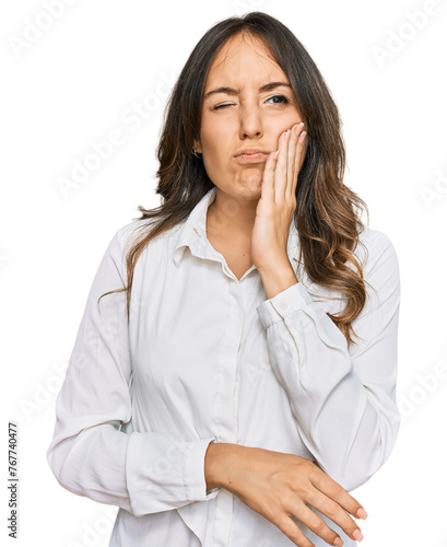 Young brunette woman wearing casual clothes touching mouth with hand with painful expression because of toothache or dental illness on teeth. dentist