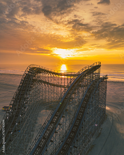 Scenic view of sunrise over the rollercoaster on the beach in Wildwood, New Jersey photo