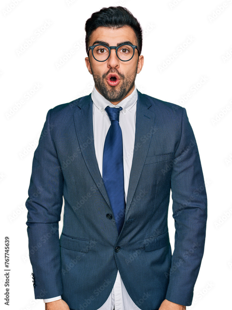Hispanic man with beard wearing business suit and tie scared and amazed with open mouth for surprise, disbelief face Hispanic man with beard wearing business suit and tie scared and amazed with open mouth for surprise, disbelief face