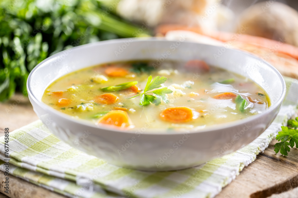 Spring vegetable soup with chopped and grated root vegetables, seasoned with yeast. Healthy vegetable vegetarian food Spring vegetable soup with chopped and grated root vegetables, seasoned with yeast. Healthy vegetable vegetarian food