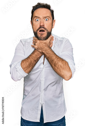 Middle age man wearing casual clothes shouting and suffocate because painful strangle. health problem. asphyxiate and suicide concept. © Krakenimages.com