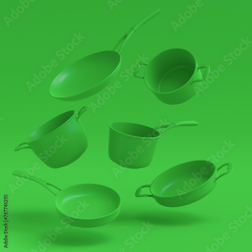 Set of flying stewpot, frying pan and plated cookware on monochrome background