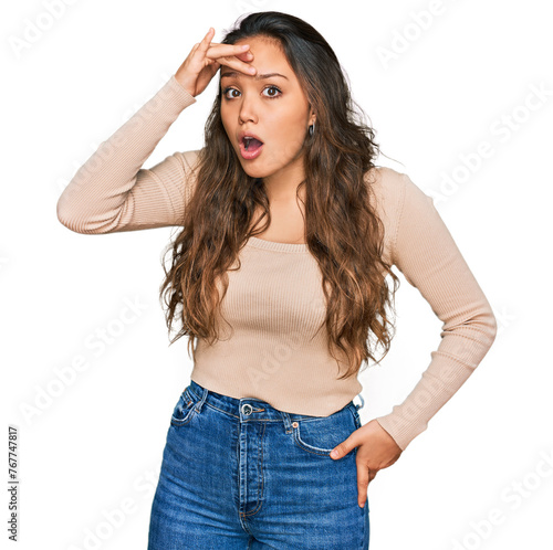 Young hispanic girl wearing casual clothes surprised with hand on head for mistake, remember error. forgot, bad memory concept.