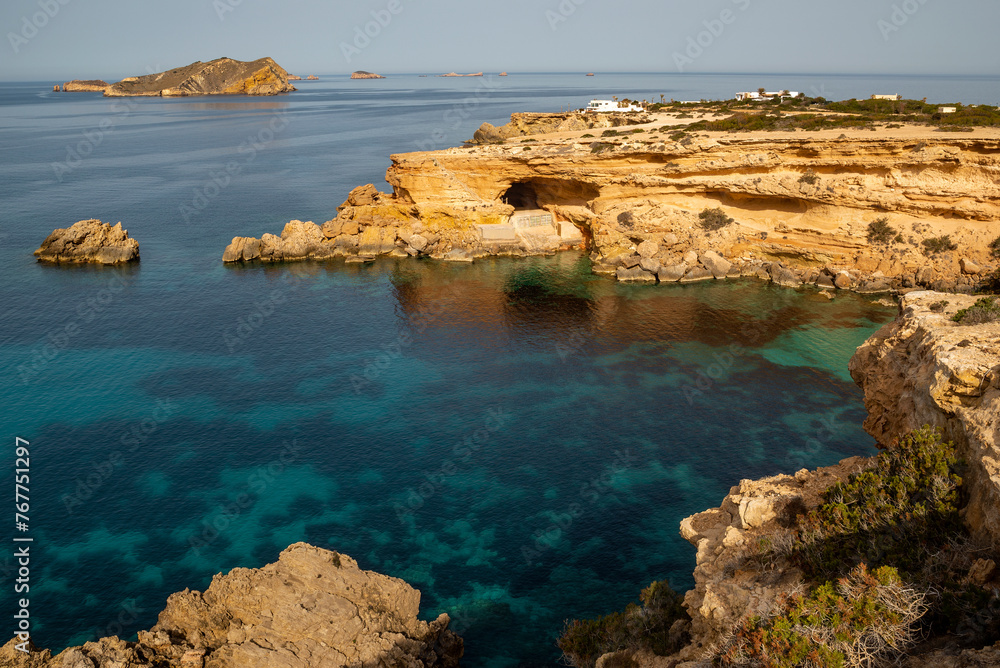 The most beautiful hidden cove with turquoise water and caves near Cala Comte beach, Sant Josep de Sa Talaia, Ibiza, Balearic Islands, Spain
