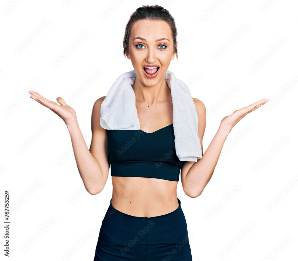 Beautiful caucasian woman wearing sportswear and towel celebrating victory with happy smile and winner expression with raised hands Beautiful caucasian woman wearing sportswear and towel celebrating victory with happy smile and winner expression with raised hands