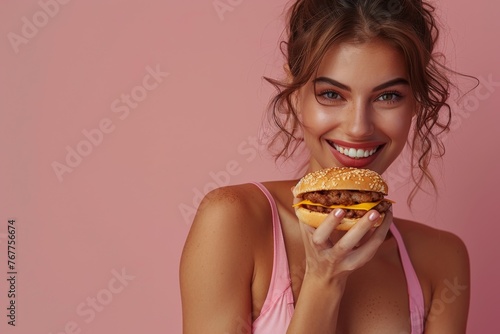 Woman with a good physique happily of junk food , on a soft-colored backdrop, representing a positive approach to nutrition and health