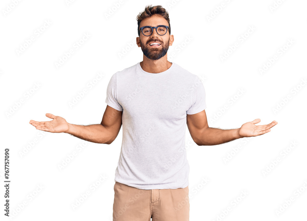 Young hispanic man wearing casual clothes and glasses smiling showing both hands open palms, presenting and advertising comparison and balance - obrazy, fototapety, plakaty 