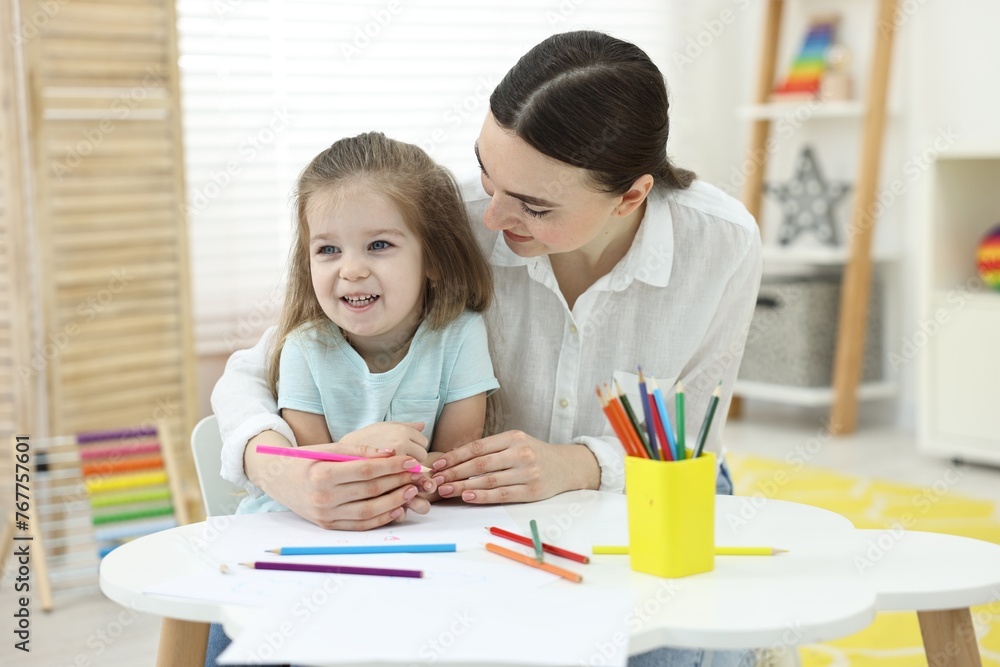 Mother and her little daughter drawing with colorful pencils at home Mother and her little daughter drawing with colorful pencils at home
