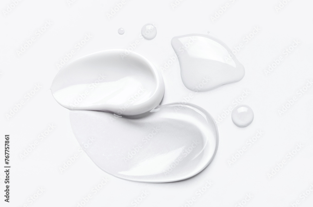 samples of cosmetic care products smear of cream and gel texture on a light background