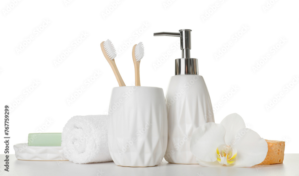 Bath accessories. Different personal care products and flower on table against white background Bath accessories. Different personal care products and flower on table against white background