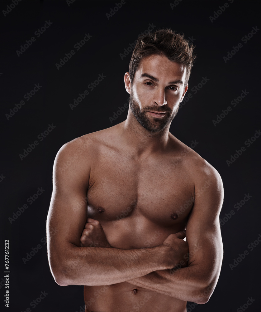 Portrait, muscle and body of confident man in studio isolated on a black background for wellness, sexy or six pack. Model, face and topless person with arms crossed for health and strong abs in Spain