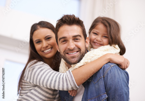 Mom, dad and girl in home for portrait with love or care, quality time and family bonding for memories or connection. Parents, child and together for comfort or safety on weekend, hug and happiness.